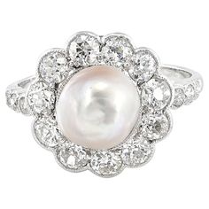 This fabulous antique Edwardian period Diamond & Pearl ring is the epitome of eternal elegance Dated 1910 circa, hand crafted of solid 18 Kt gold platinum topped Floret daisy shape in beautiful combination of silky Pearl sheen and white Diamond sparkle Central Pearl is certified natural salt water, white cream measuring 8.4 x 8.5 mm average, fabulous sheen , slightly misshaped Supporting Diamonds are bright white old European cut Diamonds totaling 1.35 Ct G/H VVS/SI Little Diamonds chasing the s Diamond Pearl Ring, Pearl And Diamond Ring, Water Pearls, Natural Pearl, European Cut Diamonds, G H, Gold Platinum, Natural Pearls, Cluster Ring