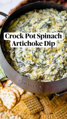 crock pot spinach artichoke dip in a skillet with crackers