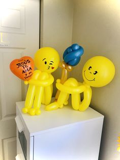 some balloons are sitting on top of a white cabinet