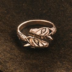 Ring in solid bronze ending in the heads of Geri and Freki (Old Norse both meaning "the ravenous" or "greedy one") - the two wolves which accompanied the Norse god Odin. The ring is adjustable in size and can fit most fingers. Can be adjusted approximately up to size 14 Material: Bronze Copyrighted design and production by Grimfrost NOTE:Do not open and close the ring repeatedly and without care. Applying too much stress can weaken the center part. Upon receiving the ring, put it on your finger Geri And Freki, Norse God Odin, Two Wolves, Odin God, Center Part, Old Norse, Wolves, Rings For Men, Two By Two