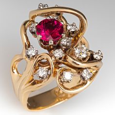 This beautiful freeform tourmaline ring is centered with a round mixed cut rubellite tourmaline, weighing an estimated 1.00 carat, in a six-prong setting. The tourmaline is accented with thirteen (13) round brilliant cut diamonds in four-prong settings. The ring measures 23.6mm at the top, rises 9.7mm above the finger, tapering to 4.4mm wide and 1.0mm thick at the base of the shank. It is currently a size 7.5. One of the accent diamonds has a small chip. Antique Rings Gold, Antique Cocktail Ring, Antique Gold Rings, Rubellite Tourmaline, Pretty Jewelry, Fancy Jewellery, Tourmaline Ring, Jewellery Design, Gem Stone