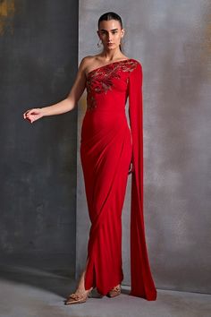 Buy Red Jersey Embroidery Plumeria Cut Dana One Shoulder Gown For Women by Namrata Joshipura Online at Aza Fashions. One Shoulder Evening Dress With Draped Sleeves For Wedding, Red One Shoulder Gown For Wedding, One Shoulder Red Gown For Wedding, Red One Shoulder Wedding Gown, One-shoulder Gown With Draped Sleeves For Wedding, One Shoulder Gown With Draped Sleeves For Wedding, Red Evening Gown With Traditional Drape, Red One Shoulder Dress For Wedding, Festive Evening Dress With Cape Sleeves For Gala