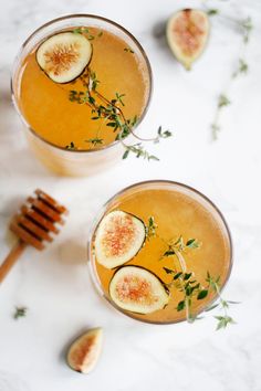 two glasses filled with liquid and sliced figs