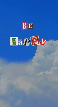 the words be happy are spelled with magnets in front of a blue cloudy sky