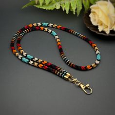 This handmade beaded lanyard combines functionality and style, perfect for carrying badges, keys, or ID cards. Inspired by Native American patterns, it's an ideal accessory for teachers, nurses, or anyone who values unique designs. 🎨  - ✨ **Handmade with care Crafted with precision and attention to detail.  - 🌈 **Eye-catching design Vibrant bead patterns in a Native-inspired style.  - 📏 **Customizable length Standard sizes are 15 and 19 inches, but custom lengths are available upon request.  - 🎁 **Great gift idea Perfect for teachers, coworkers, or friends who need a stylish way to carry essentials.  - 🛠️ **Versatile use Ideal for badges, keys, or ID cards with a secure and durable clasp.  Add a touch of color and craftsmanship to your daily routine! 😊 Beaded Lanyard Patterns, Lanyard Patterns, Indigenous Beading, Native American Patterns, Beadwork Ideas, Beaded Lanyard, Beaded Lanyards, Beaded Rope, Native American Style