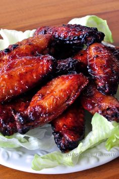 grilled chicken wings on a plate with lettuce