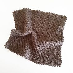 two crocheted dishcloths sitting next to each other on a white surface