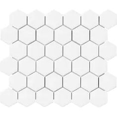 white hexagonal tiles on a white background with no one in the photo looking at them