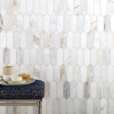 a table with a plate and cup on it in front of a marble tiled wall