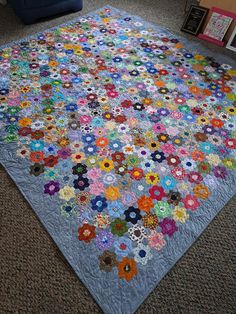 a large quilt is laying on the floor