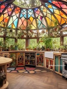 a kitchen with lots of potted plants in the center and stained glass on the ceiling