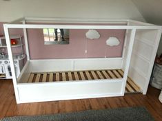 a dollhouse bed with pink walls and white furniture