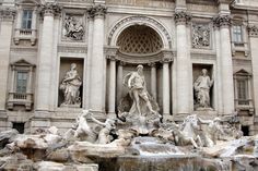 there is a fountain in front of the building