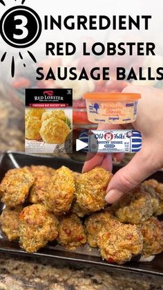 a person is grabbing some food out of a pan with the words red lobster sausage balls on it