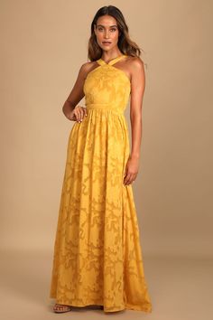 a woman in a yellow dress posing for the camera with her hands on her hips