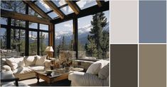 a living room filled with furniture and windows covered in shades of gray, white and beige