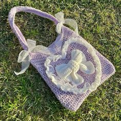 a crocheted purse sitting in the grass