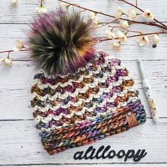 a knitted hat with a pom - pom on top