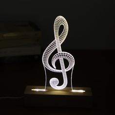 an illuminated musical note on a wooden stand