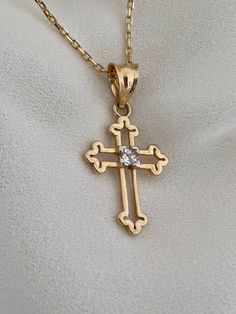 "This is a 14k yellow solid gold (not filled or plated) hollow cross necklace furnished with a tiny shiny cubic zirconia diamond. The necklace is easy to wear alone or layered with something else. This also makes the perfect gift. - 14K SOLID GOLD - WEIGHT: 2.10 gr - Necklace LENGTH: 19 3/4\" - PENDANT LENGTH: 7/8\" Each item comes in a beautiful gift box. HOW TO CARE FOR YOUR JEWELRY: + Unlike any gold-filled, plated, or vermeil jewelry that is not solid gold, wet areas, perfumes, and lotions w Gift Cross Necklace With Diamond Accents, Diamond Crucifix Cross Necklace For Gift, Gold Diamond Cut Cross Necklace, Diamond Crucifix Cross Necklace As Gift, Crucifix Necklace With Vvs Clarity As Gift, Gift Crucifix Necklace With Vvs Clarity, Gift Crucifix Necklace Vvs Clarity, Vvs Clarity Crucifix Jewelry Gift, Diamond Cut Cross Necklace As Gift