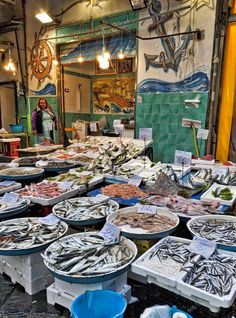 an outdoor market with many different types of seafood