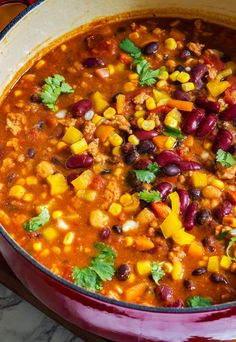 a red pot filled with chili and beans