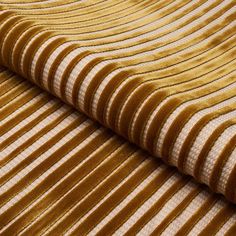 a close up view of a yellow and white striped fabric