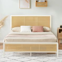 a bed with wicker headboard and pillows on top of it in a bedroom