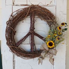 a peace sign wreath with sunflowers on a door