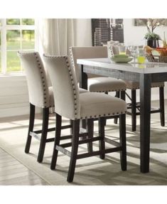 a dining room table with four chairs around it