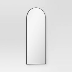 an arched mirror is shown against a white wall