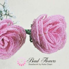 two pink flowers made out of beads on a white background with the words bead flowers above them