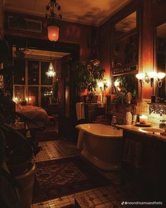 a bath tub sitting next to a sink in a bathroom with candles on the wall