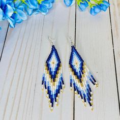 These colorful beaded earrings are sure to add a cute pop of color to any boho chic look or summer outfit. Part of our Azula Collection, these bohemian fringe earrings feature beautiful fall colors: Navy Blue, Light Blue, White, Beige/Ivory, and Gold. With an Exclusive Colorful 4U design, these seed bead earrings in boho chic style are part of the traditional Emberra art and culture, combining stylish designs with ancient tribal patterns and craftsmanship. Details: Lightweight long statement ear Bohemian Blue Earrings For The Beach, Bohemian Blue Earrings For Beach, Blue Beaded Fringe Tassel Earrings For Festivals, Blue Bohemian Earrings With Dangling Beads, Bohemian Blue Earrings With Dangling Beads, Blue Fringed Beaded Earrings For Festival, Bohemian Blue Fringe Tassel Earrings, Blue Bohemian Dangle Tassel Earrings, Bohemian Blue Dangle Tassel Earrings