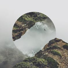 an image of the sky and clouds reflected in a circular mirror on top of a mountain