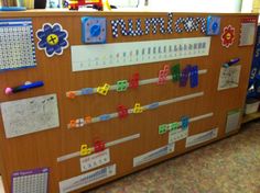 a bulletin board with numbers and magnets on it in a school classroom room or playroom