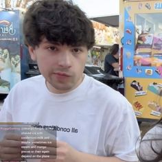 a man and woman standing next to each other in front of a vending machine