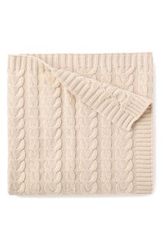 a white blanket with cable knits on it