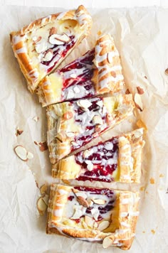 puff pastry danish with raspberry sauce on top and almonds around the edges