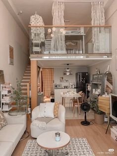 a living room filled with furniture and a stair case in the middle of the room