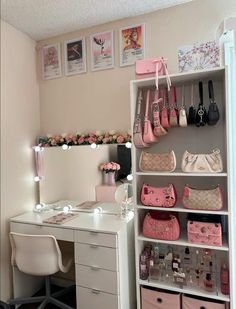 a white desk topped with lots of drawers and pink purses on top of it