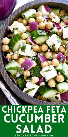 a wooden bowl filled with chickpeas and cucumber salad