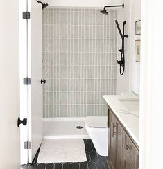 a bathroom with black and white tile flooring