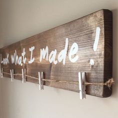 a wooden sign that says i look what i made with clothes pins and rope hanging on the wall