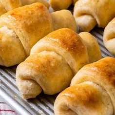 rolls are lined up on a baking rack