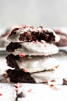 a stack of cookies with white frosting and candy canes