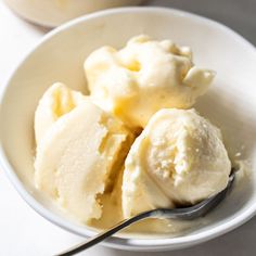 two bowls filled with ice cream on top of a white table next to each other