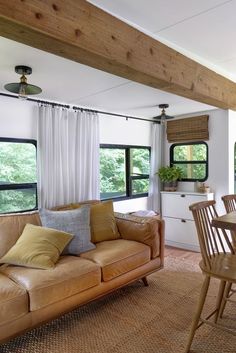 a living room filled with furniture and windows