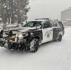 a police car is parked in the snow