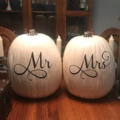 two white pumpkins with the word mr and mrs painted on them sitting on a table